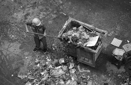 Workers managing demolition debris on a construction site in Merton