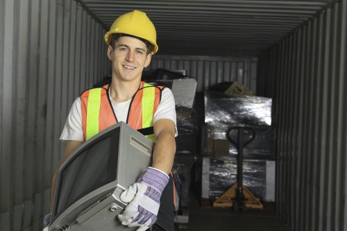 Construction workers loading waste into a skip